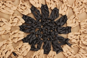 Macro shot of circular hollow paper rope weaving pattern on a beach straw handbag