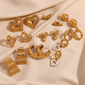Elegant 18K gold plated stainless steel heart and geometric earrings on silk background