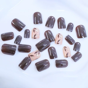 Short square press-on nails featuring vintage brown leaves and golden glitter finish