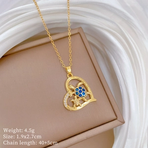 Detail of gold heart pendant necklace featuring sea turtles with blue shell inlay and gems