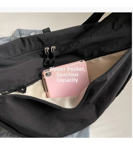 Detail view of spacious black nylon bag interior with double zippers and inner pocket