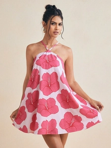 Detail of pink floral halter mini dress featuring vibrant hibiscus print and A-line silhouette
