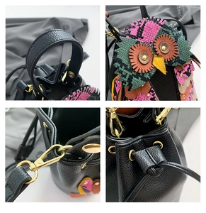 Detail of owl bucket bag with patchwork snake pattern and gold-tone metal hardware