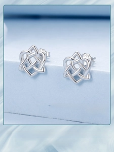 Macro shot of S925 sterling silver Celtic knot stud earrings with intricate heart weave