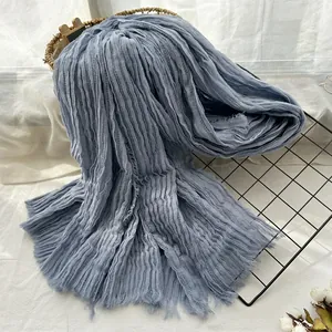 Light blue crinkle scarf with fringe detail and soft pleated texture for women and men