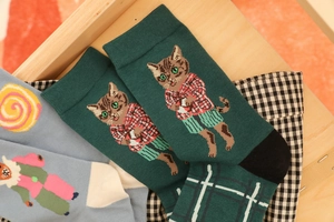Close-up of dark green cotton socks featuring cute cartoon cat jacquard patterns