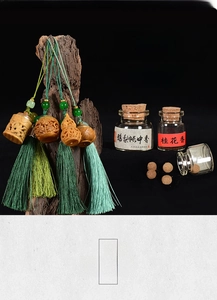 Close-up of handcrafted carved wood incense pendants with silk tassels and aroma pellets