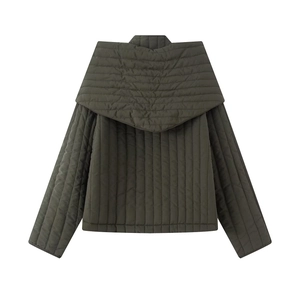 Detail of dark green quilted jacket featuring a wide shawl lapel and diamond stitching