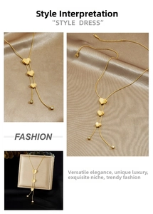 Close-up of gold plated Y-shaped necklace with frosted heart pendants and zircon detail