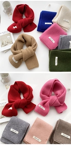Collection of colorful knitted winter scarves displayed with aesthetic accessories