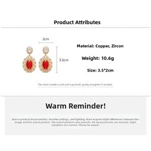 Detailed view of red oval zircon earrings with gold plating and silver needles