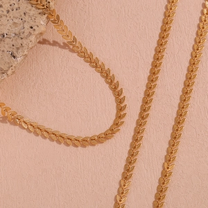Detailed close-up of 18K gold plated stainless steel necklace with leaf shape chain links