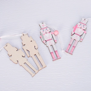 Pink and white wooden nutcracker Christmas ornaments set on white wood background