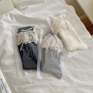 Lace ruffle mid-calf socks set with ribbon bows in navy, grey, and cream colors