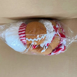 Gingerbread man wine bottle cover made of soft plush fabric inside a packaging box