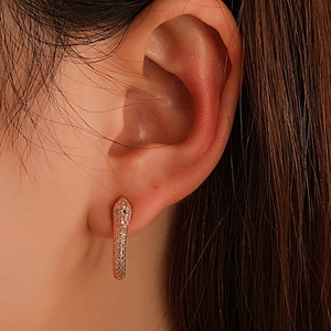 Exaggerated rose gold snake earrings with sparkling cubic zirconia on model