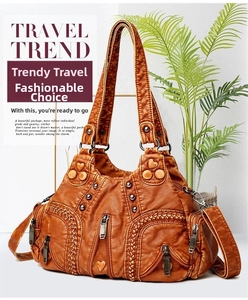Close-up of vintage brown PU leather handbag with zipper pockets and metal rivets