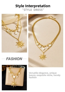 Macro detail of double-layer gold sun pendant necklace with marble beads in a jewelry box