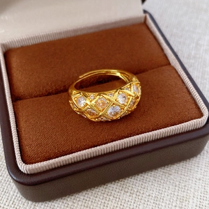 Detailed macro view of 24k gold plated lattice ring with sparkling cubic zirconia crystals