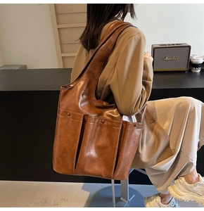 Brown large capacity leather tote bag shown on model for daily commuting style