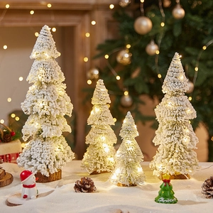 Mini flocked Christmas trees with LED lights and snow effect for holiday tabletop decor