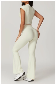 Detailed side-back view of high-waist flared yoga pants and cropped top in creamy white