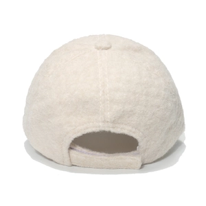 Detail view of the soft teddy fleece texture and adjustable strap on the beige cap
