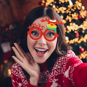 Close-up of red glitter Christmas glasses with reindeer motif and Xmas text on a model