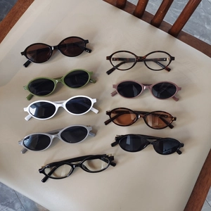 Variety of oval frame sunglasses and clear lens glasses in multiple colors for children