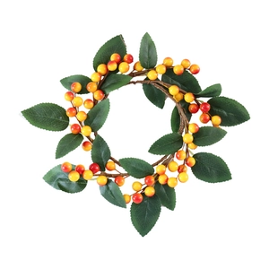 Artificial candle ring wreath with orange berries and green leaves for festive table decor