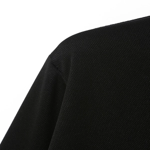 Detail of breathable pique knit fabric and shoulder seams on this black men's polo shirt