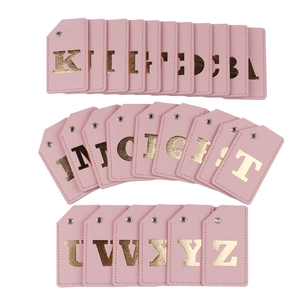 Detailed grid of pink PU leather luggage tags with golden A-Z alphabet foil letters