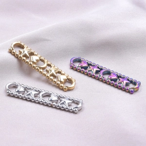 Detail of star, heart, and moon connectors in gold, silver, and rainbow steel