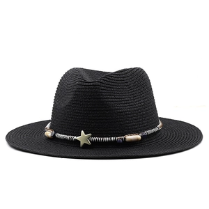 Close-up of black straw sun hat with woven star charm and multicolor bead decoration