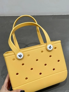Detail view of the yellow EVA waterproof beach tote showing side texture and white logo