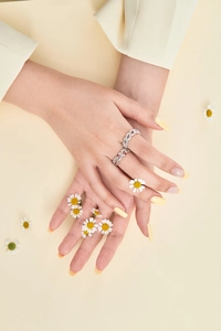 Close-up of S925 sterling silver rings with red and white zircons on a model's hand