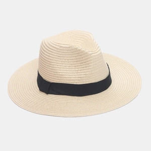 Detail view of the woven straw texture and elegant black ribbon on the panama hat