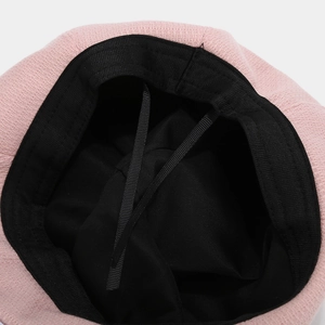 Detail view of pink beret hat showing black inner lining and adjustable drawstring