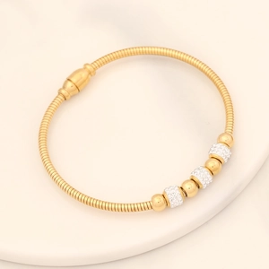Detail of gold snake chain bracelet featuring alternating crystal pavé and polished beads
