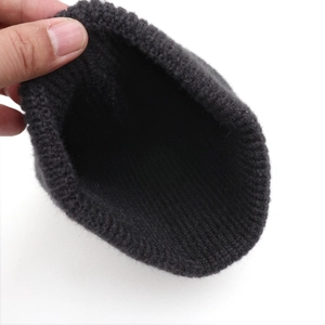 Close-up of thick ribbed knit texture and interior detail of a charcoal cat ear hat