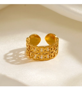 Macro detail of gold adjustable double-layer chain ring on elegant white silk fabric