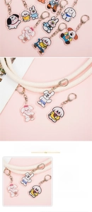 Detail view of cute acrylic animal keychains with silver metal rings on pink backdrop