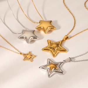 Detail of five stainless steel star necklaces in gold and silver, hollow and solid styles