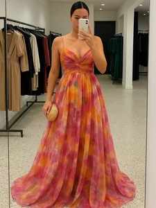 Detail of V-neck mesh dress with gradient sunset print and flowing chiffon fabric