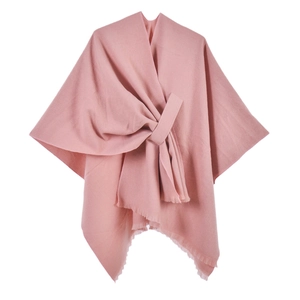 Chic pink knitted poncho for women featuring elegant fringe edges and a front knot design