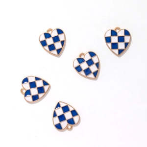 Detail of five heart-shaped pendants with blue and white plaid enamel and gold edges