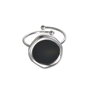 Minimalist 18K gold titanium steel ring with irregular black shell inlay on white background