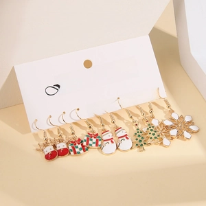 Detail of 5-pair Christmas earring set with enamel charms on white card display