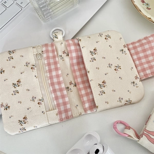 Detail of floral canvas wallet showing internal card slots and pink checkered lining