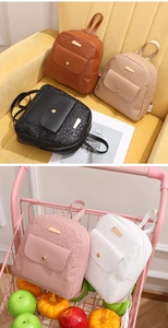 Detail of mini PU leather backpack with heart embossed pattern and magnetic flap closure